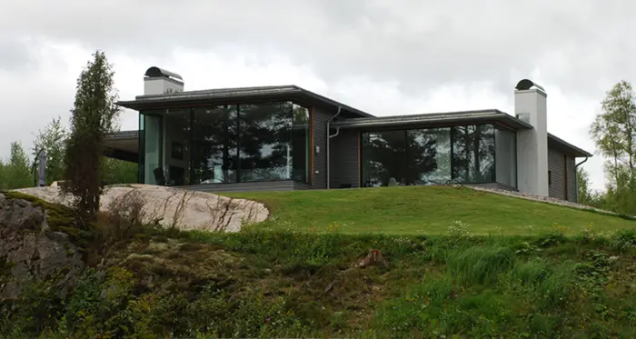 FÅG1 — bolig med to forskjøvne fløyer under flate tak, med gjennomgående glass mot plenen og svaberget